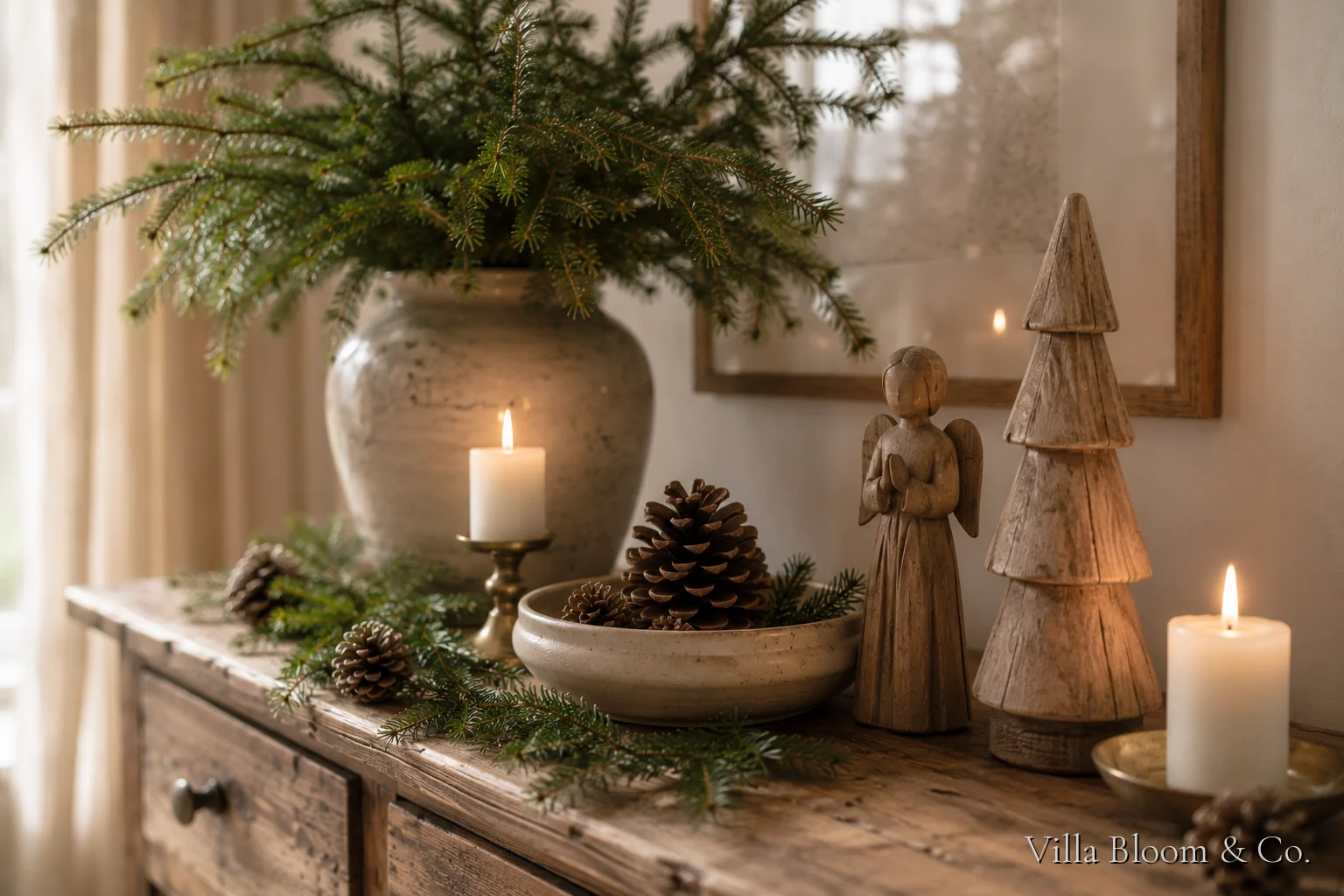 Sideboard with fir greenery, white candles and a wooden angel figure in country style
